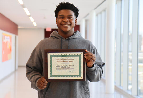 Farmer with award from March 8 ceremony