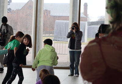 Elementary students create body art for high school students to photograph.