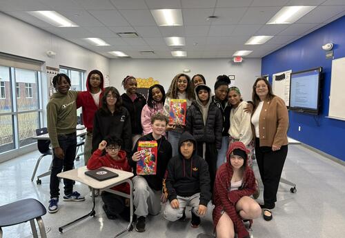 A CTE class poses with Fruit Loops after completing a lab.