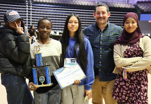 Group of students with teacher Christopher Austen holding the third place trophy