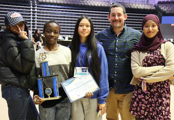 Group of students with teacher Christopher Austen holding the third place trophy