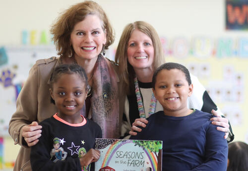 Senator Fahy posing with second-graders and their teacher