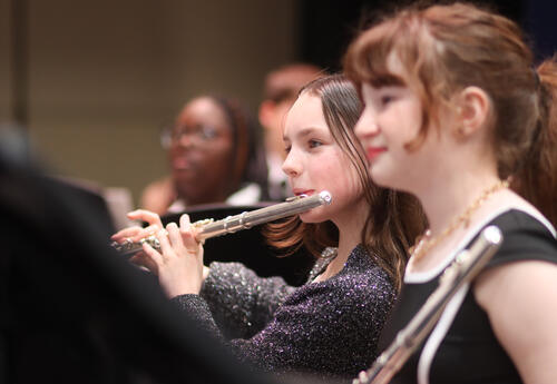 Elementary student playing the flute