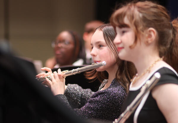 Elementary student playing the flute