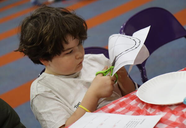 A student completes a fraction art project.