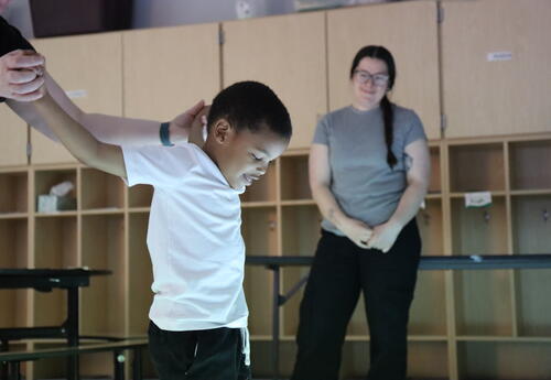 A student practices sight words with a floor projector.