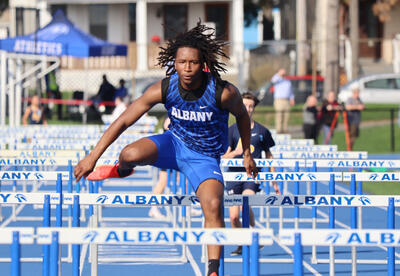 Rayon Baker running the hurdles