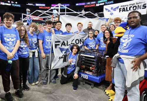 Robotics team posing with their robot