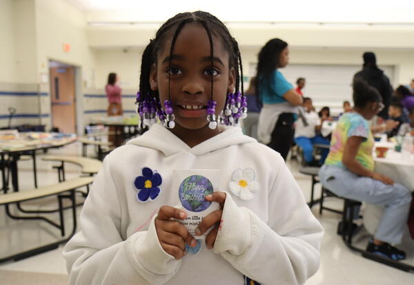 student holding earth day packet