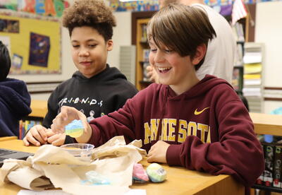 Two students conduct an experiment at the science fair.