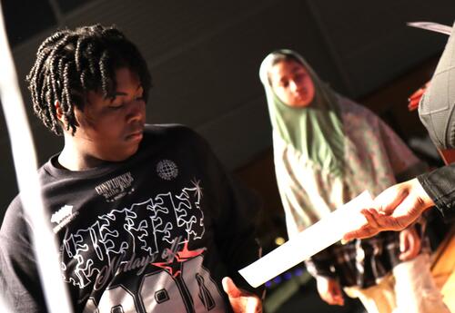 Students accept their honor roll certificates.