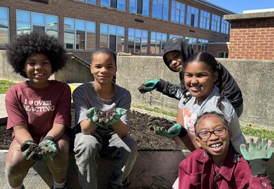 students posing with garden