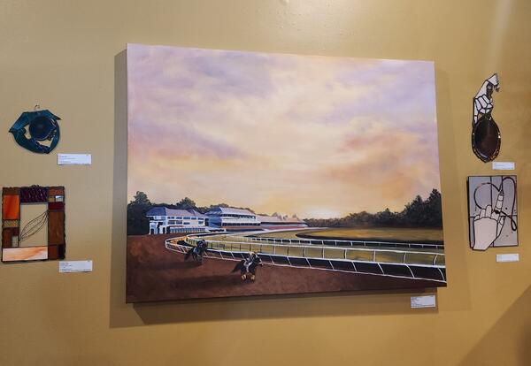 A painting created by an art teacher is on display at a local coffee shop.