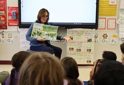 Women reading to students