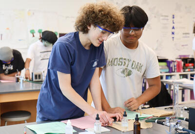 Two students completing their labwork
