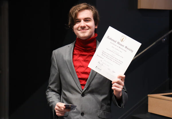 National Honor Society inductee with pin and certificate