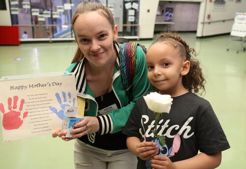 A mom and daughter pose during a Mother's Day celebration.