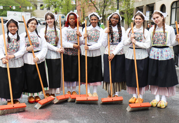 Albany high students Susie Hai, Adamarys Viveros, Anna Ustin, Karma Jernigan, Yanaiza Correa Fredericks, Sanaya Brown, Hailey Farrell and Sienna Stewart holding brooms on State Street