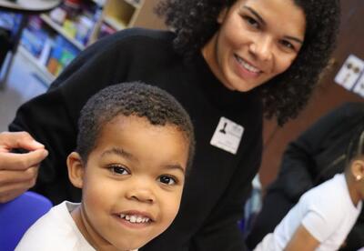 A student and his mom enjoy a Mother's Day event.