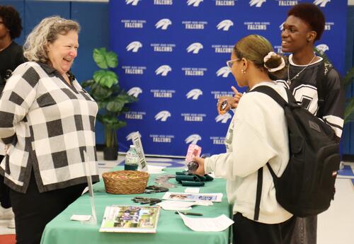 Students connecting with a business representative at Career Fair 2025