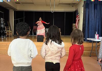 Students enjoy watching a dancer at a Multicultural Festival.