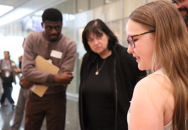 A student presents her science project to representatives from the University at Albany