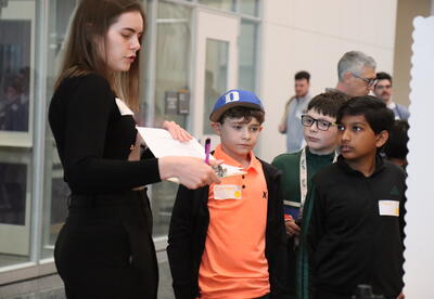Students present research during a science fair.