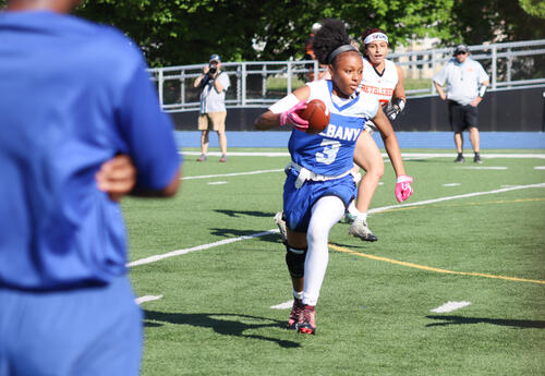 Photo of Albany High player running with the ball
