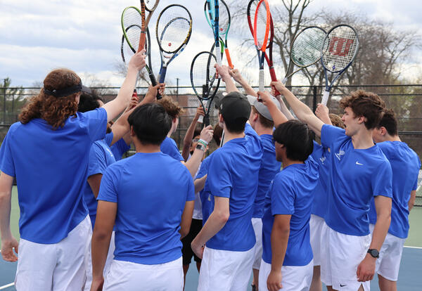 Group shot of tennis players with rackets