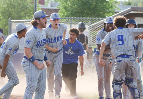 Team celebrating together after Pupon's homer
