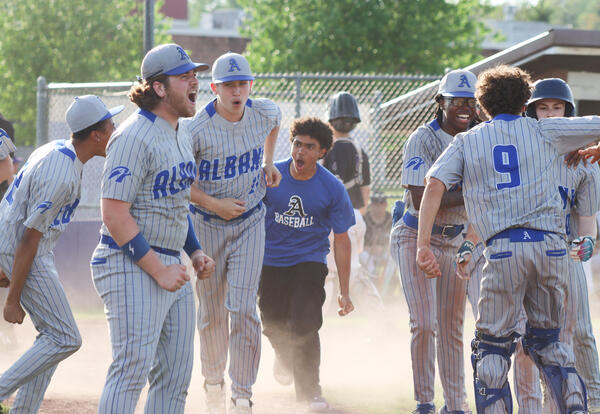 Team celebrating together after Pupon's homer