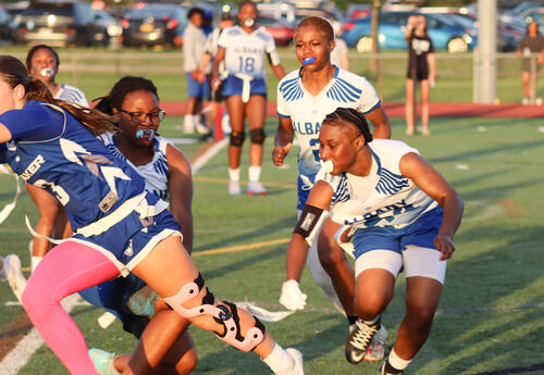 Janae Byrams pulling a flag