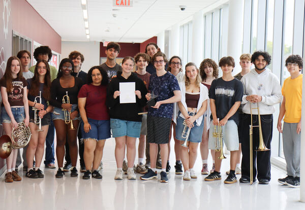 Student-orchestra holding trophy