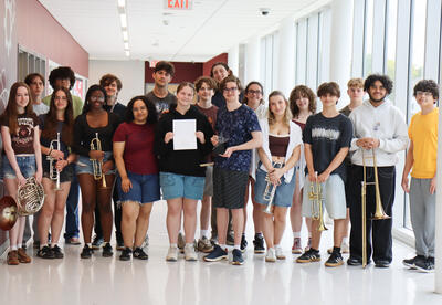 Student-orchestra holding trophy
