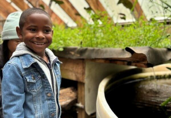A student attends a field trip to an urban farm.