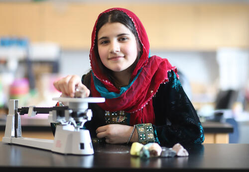 Student using a triple beam balance