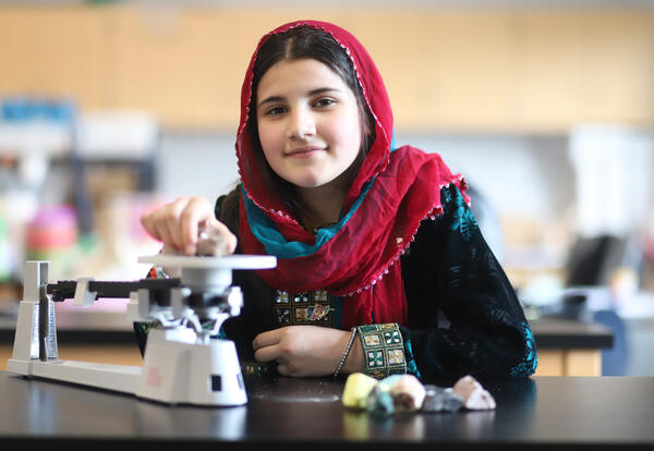 Student using a triple beam balance