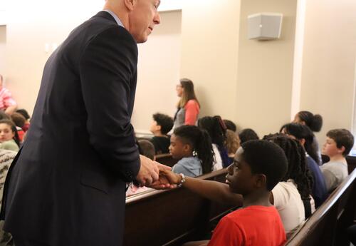 The Albany County DA shakes hands with students.
