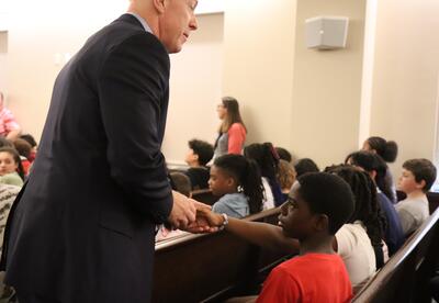 The Albany County DA shakes hands with students.