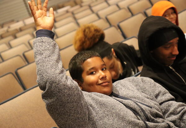 A student asks a question at a college forum.