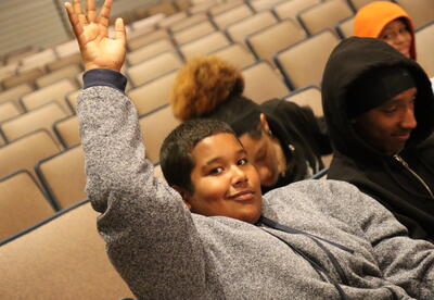 A student asks a question at a college forum.