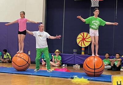 Students balance during a circus performance.