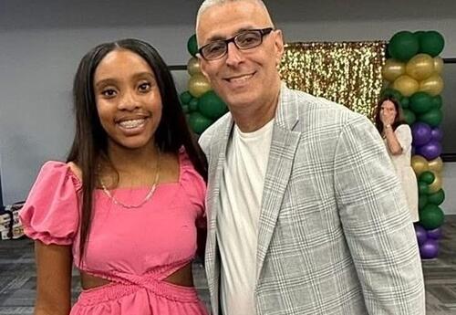 A student and the Hackett principal pose at an award ceremony