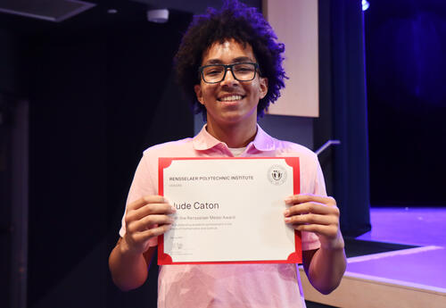 Student holding an award