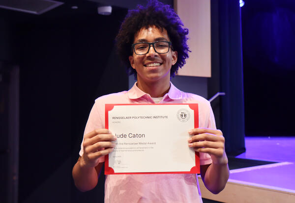 Student holding an award