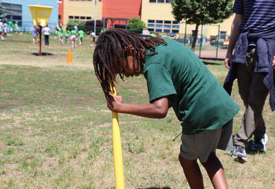A student participates in a spinning game during field day.