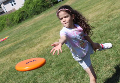 A student throws a frisbee during field day.