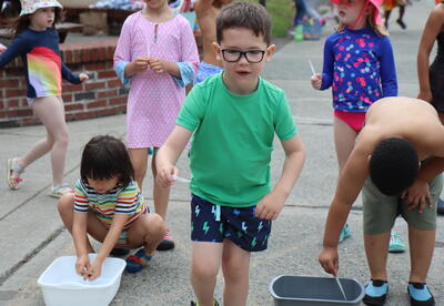 A student participates in a water relay.