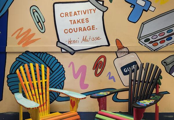 Two Adirondack chairs decorated by North Albany Middle School students.