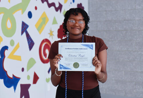 Pringle holding up certificate